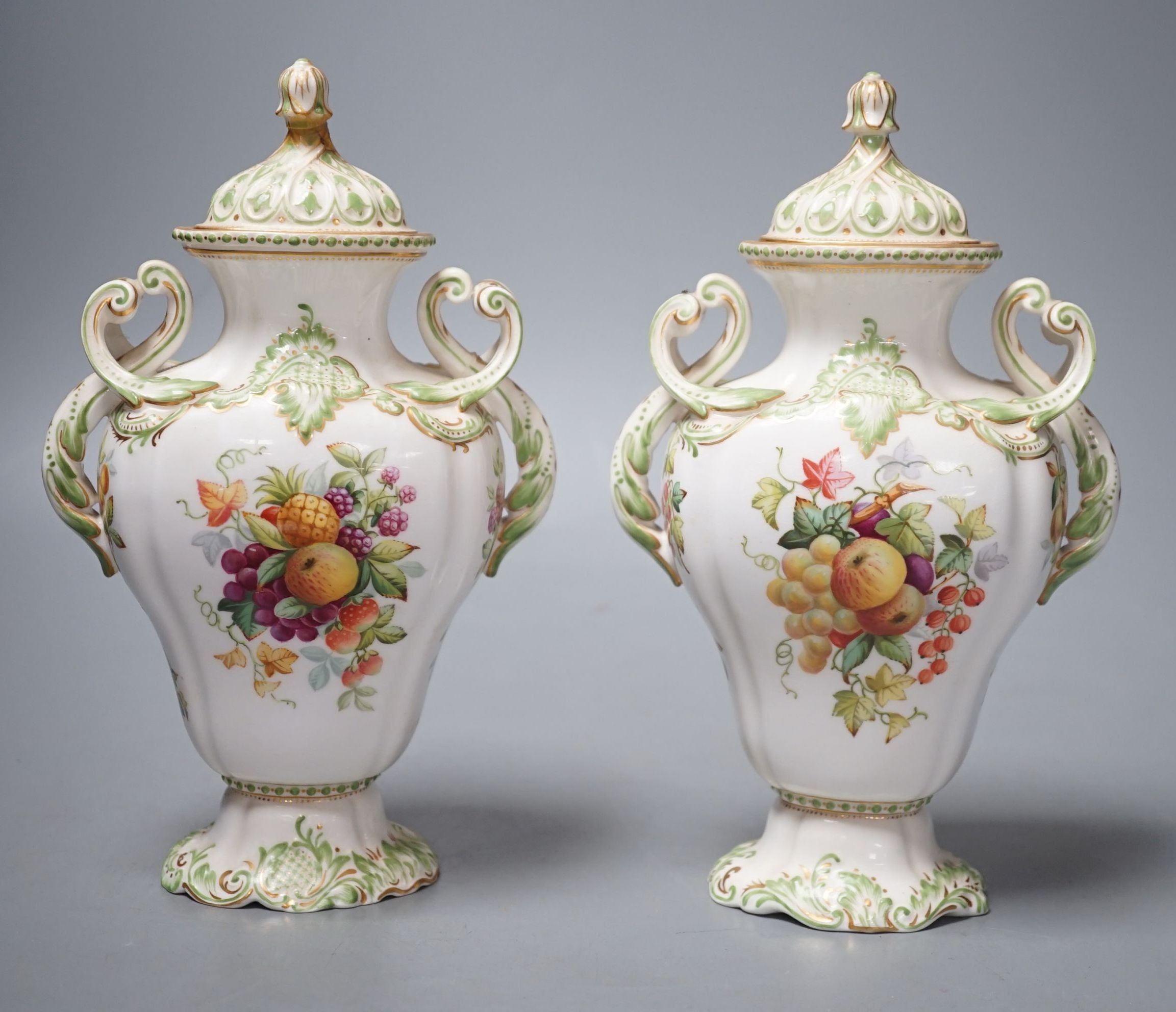 A pair of Copelands London, fruit decorated two handled vases and covers, circa 1900- 20cms high.